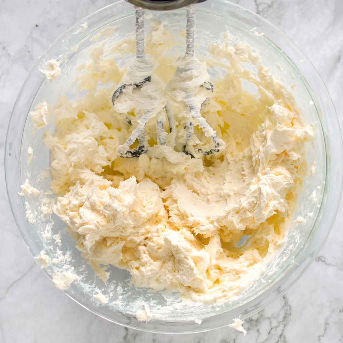 whipping butter and cream cheese with an electric hand mixer