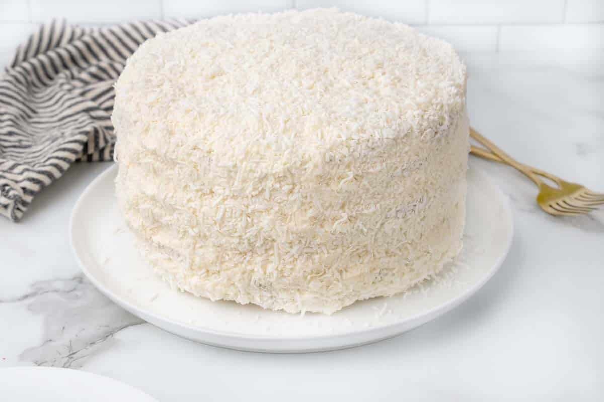 whole coconut cake on white platter