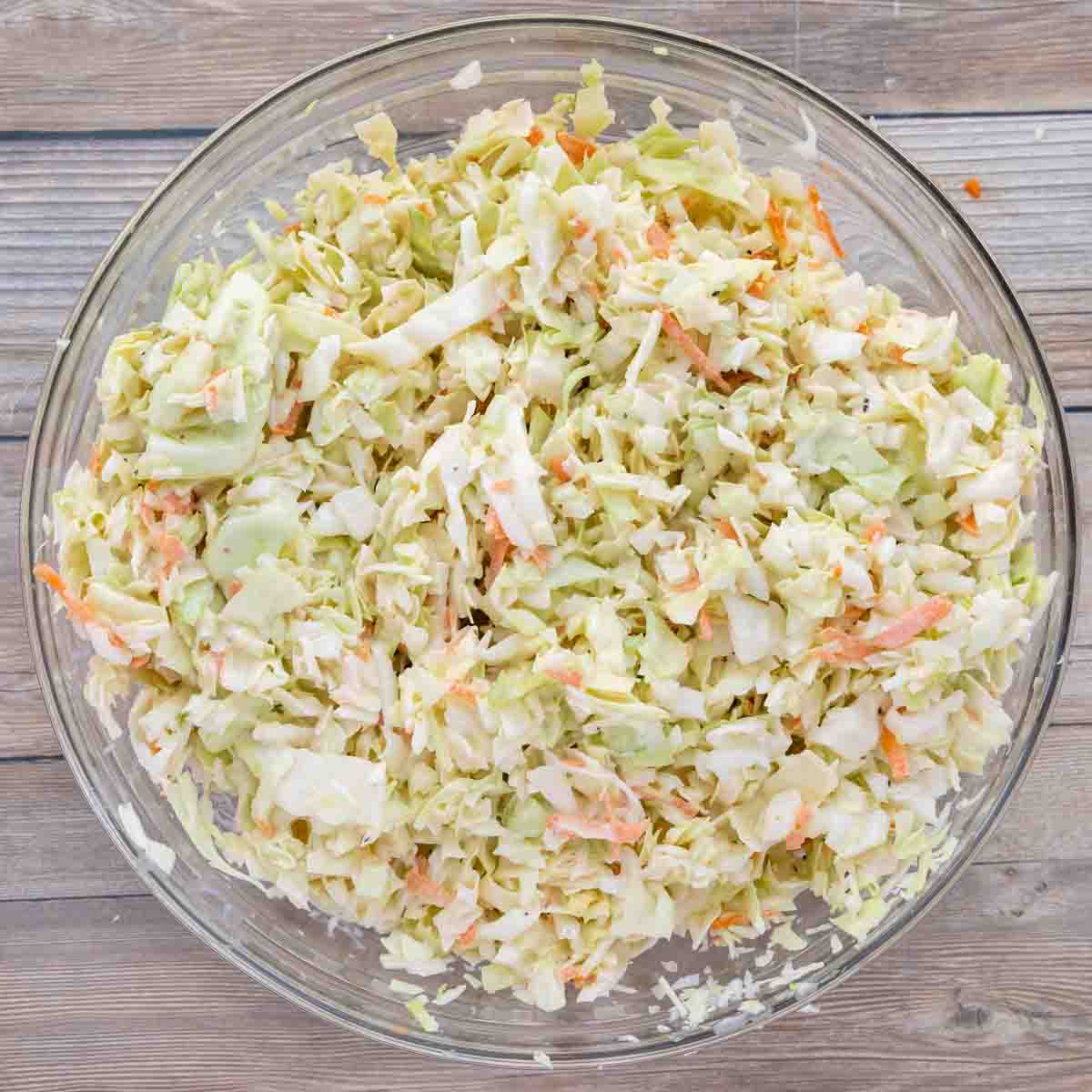 creamy coleslaw in a glass bowl.