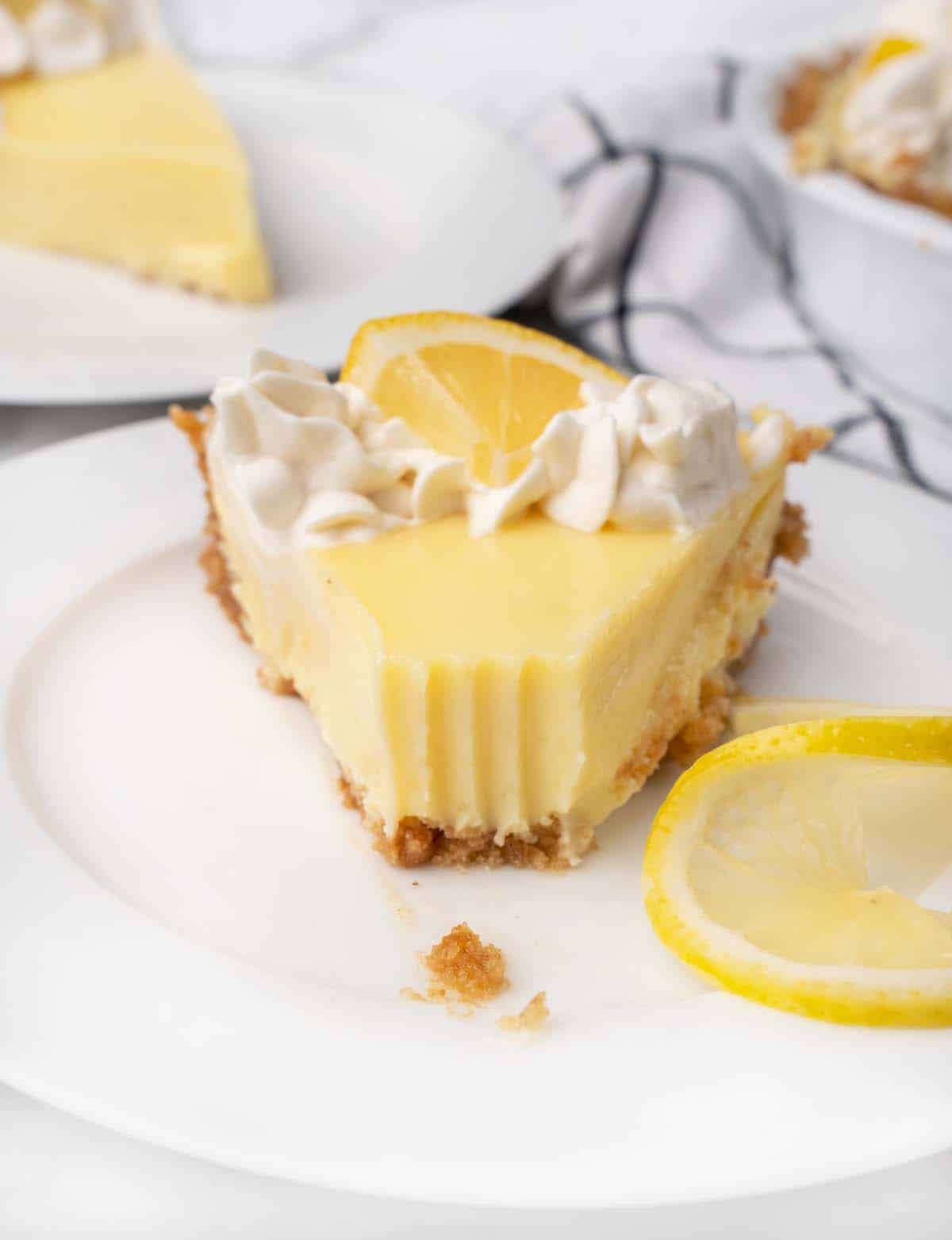slice of lemon cream pie with fork marks on front