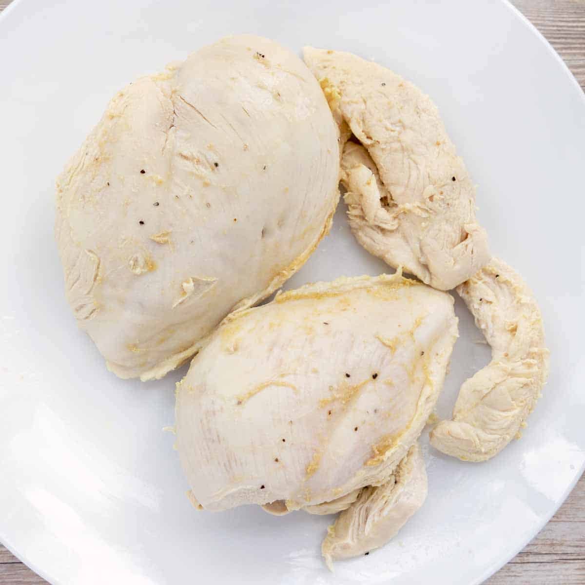 poached chicken breast on white plate