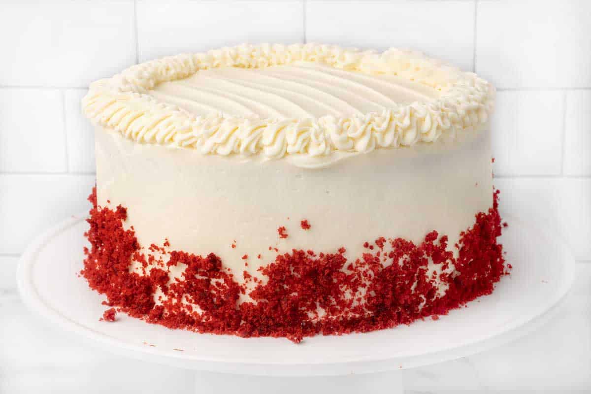Red Velvet cake on a white cake pedestal.