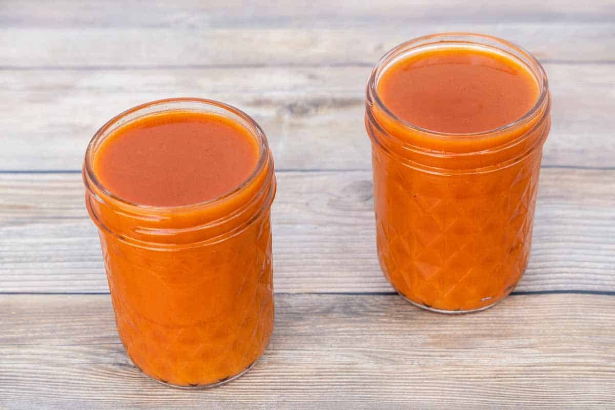 buffalo sauce in two glass canning jars.