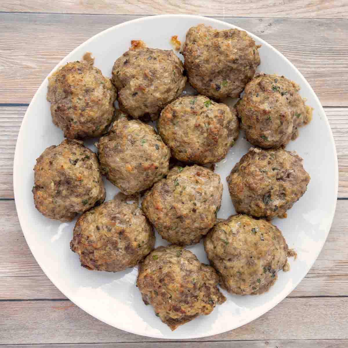 baked meatballs on a white plate.