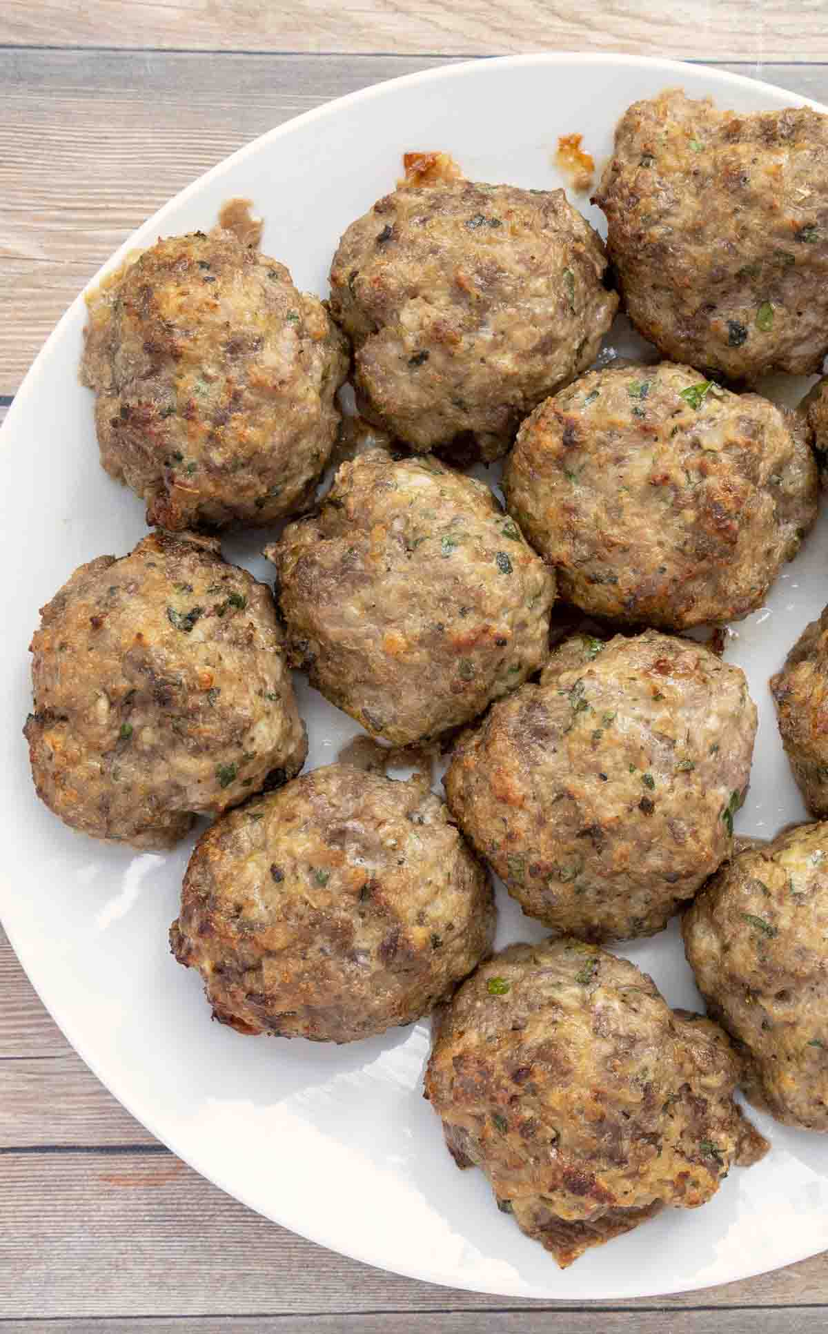 baked meatballs on a white plate.