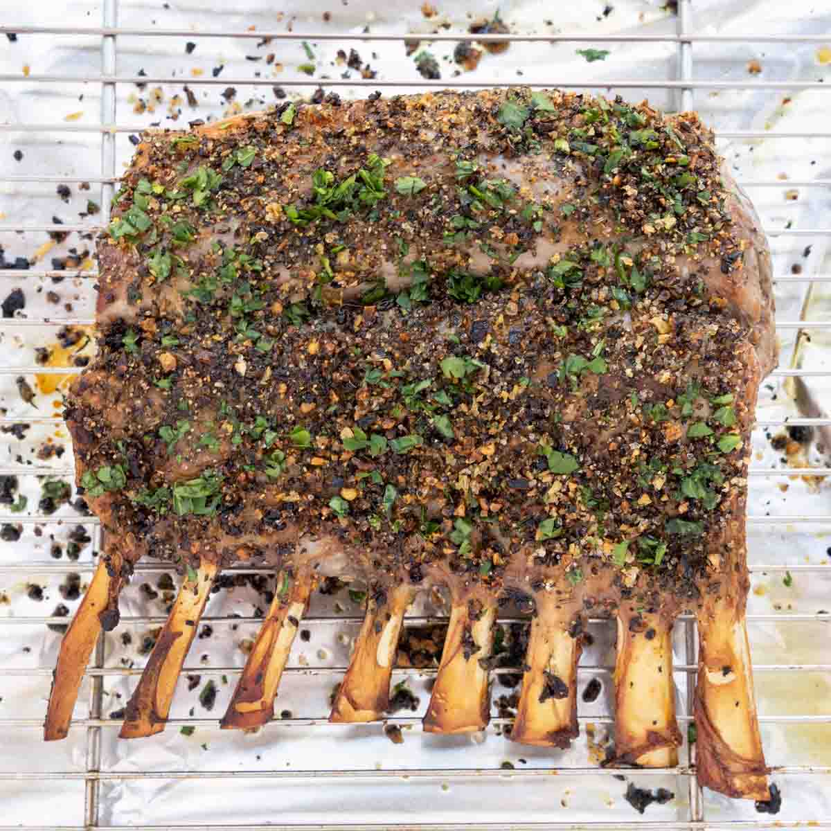cooked rack of lamb on foil lined baking pan.