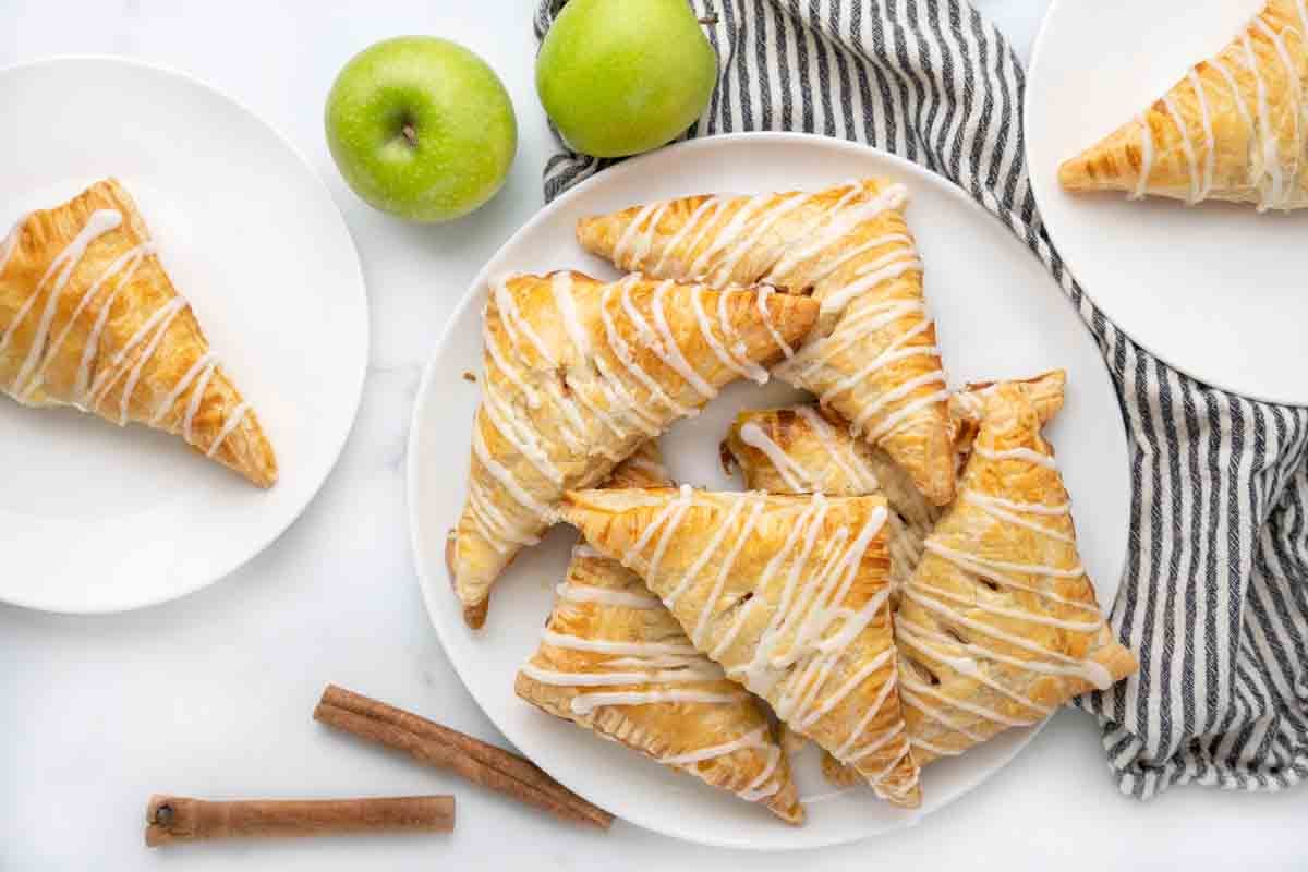 apple turnovers on white platter.