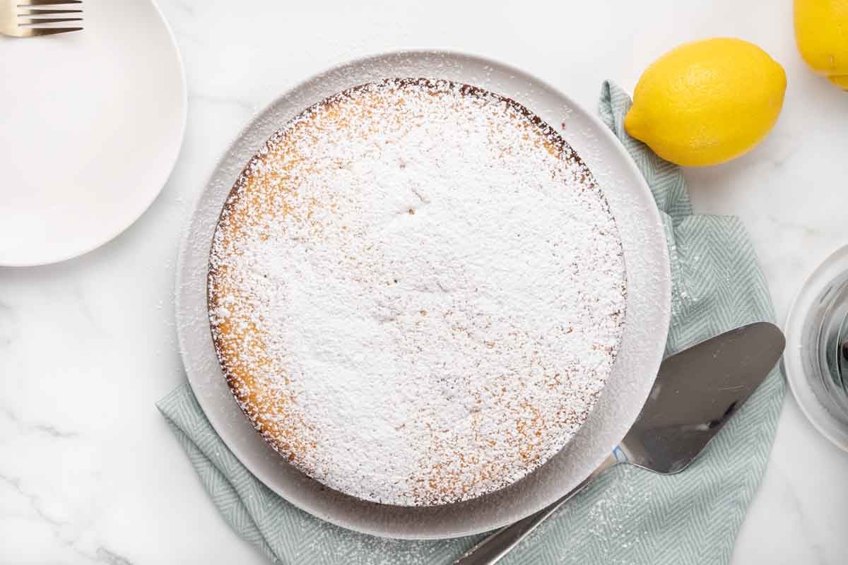 Lemon ricotta cake dusted with confectioners sugar.