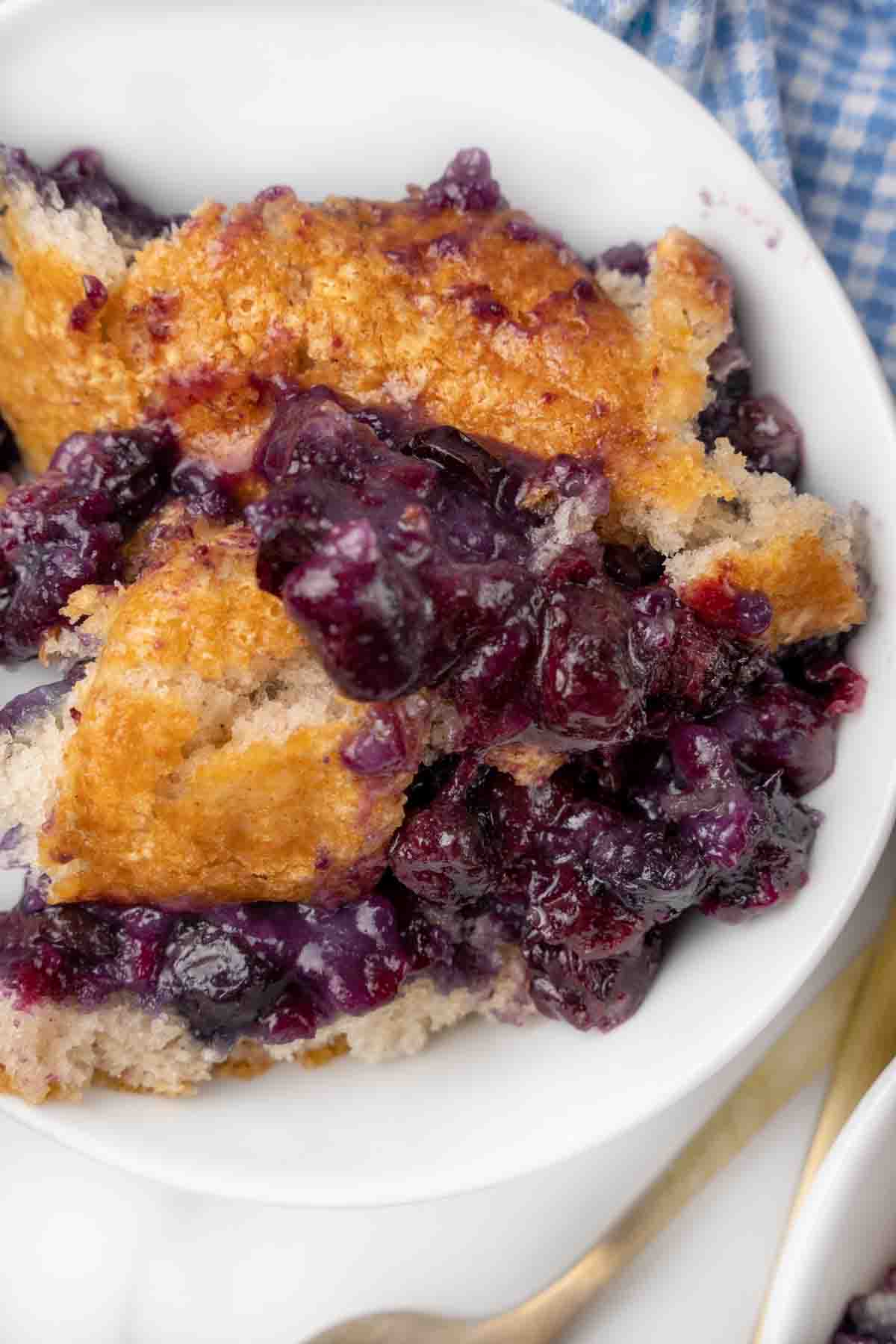 Blueberry cobbler in a white bowl.