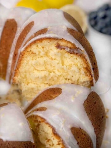 Sliced whole lemon bundt cake showing inside of cake.