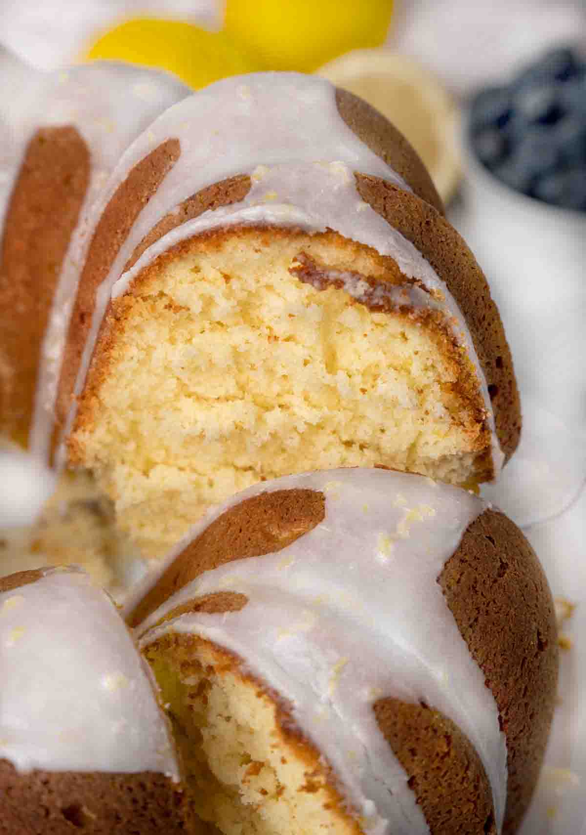 Sliced whole lemon bundt cake showing inside of cake.