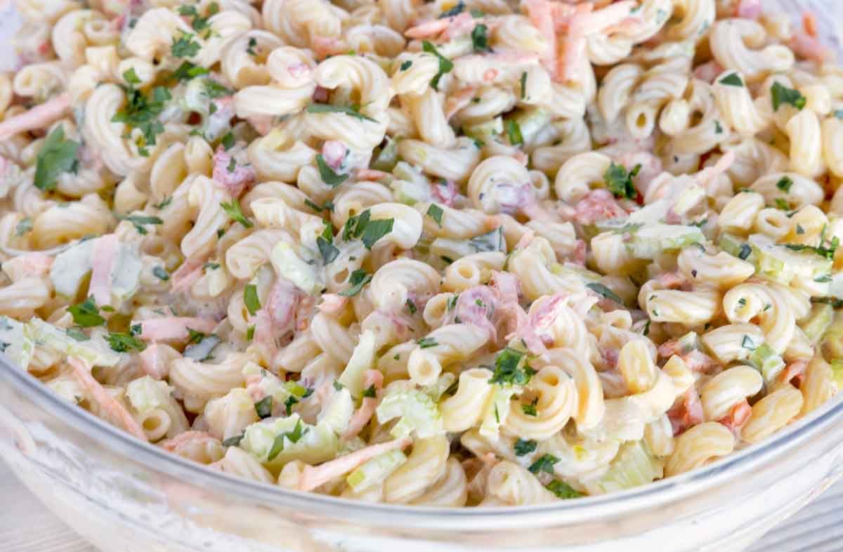 close up of macaroni salad in a glass bowl.