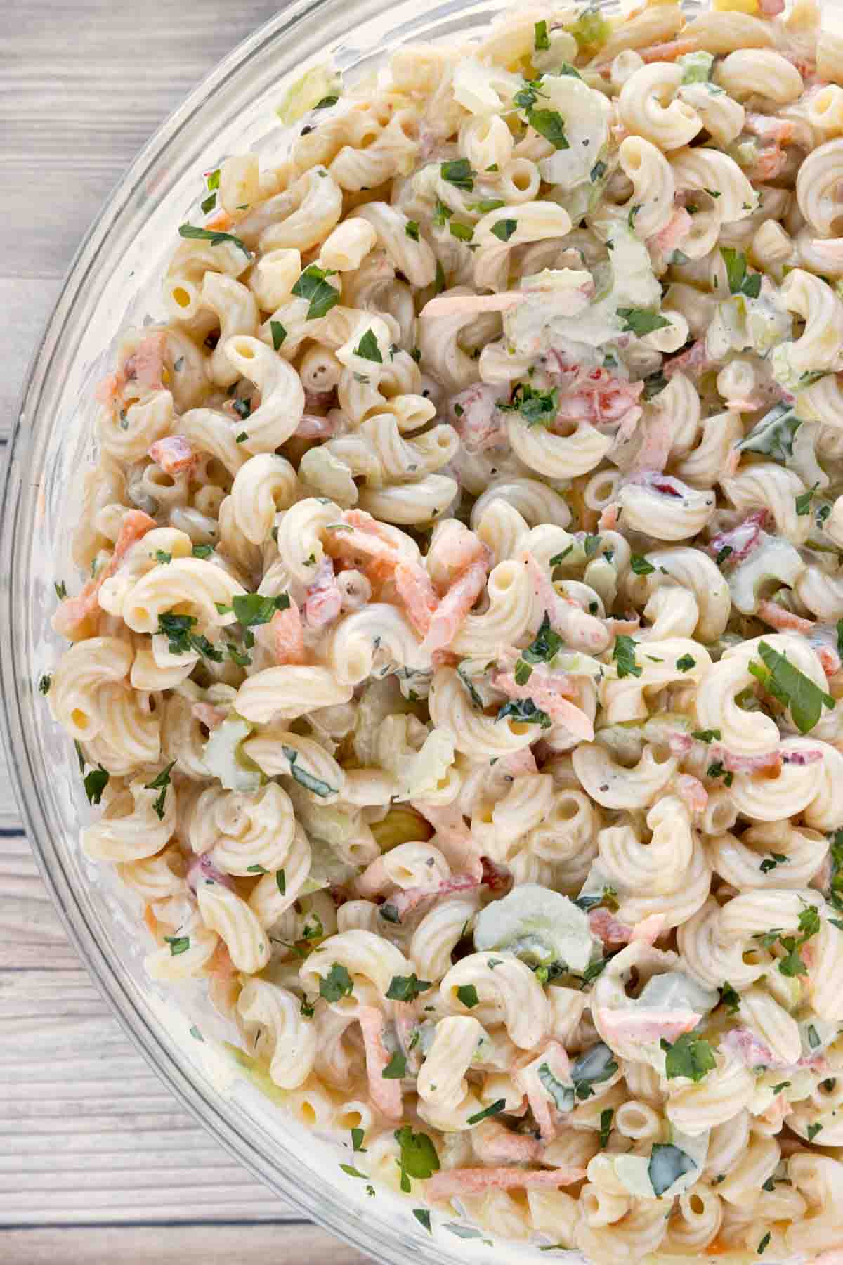 Macaroni salad in a glass bowl.