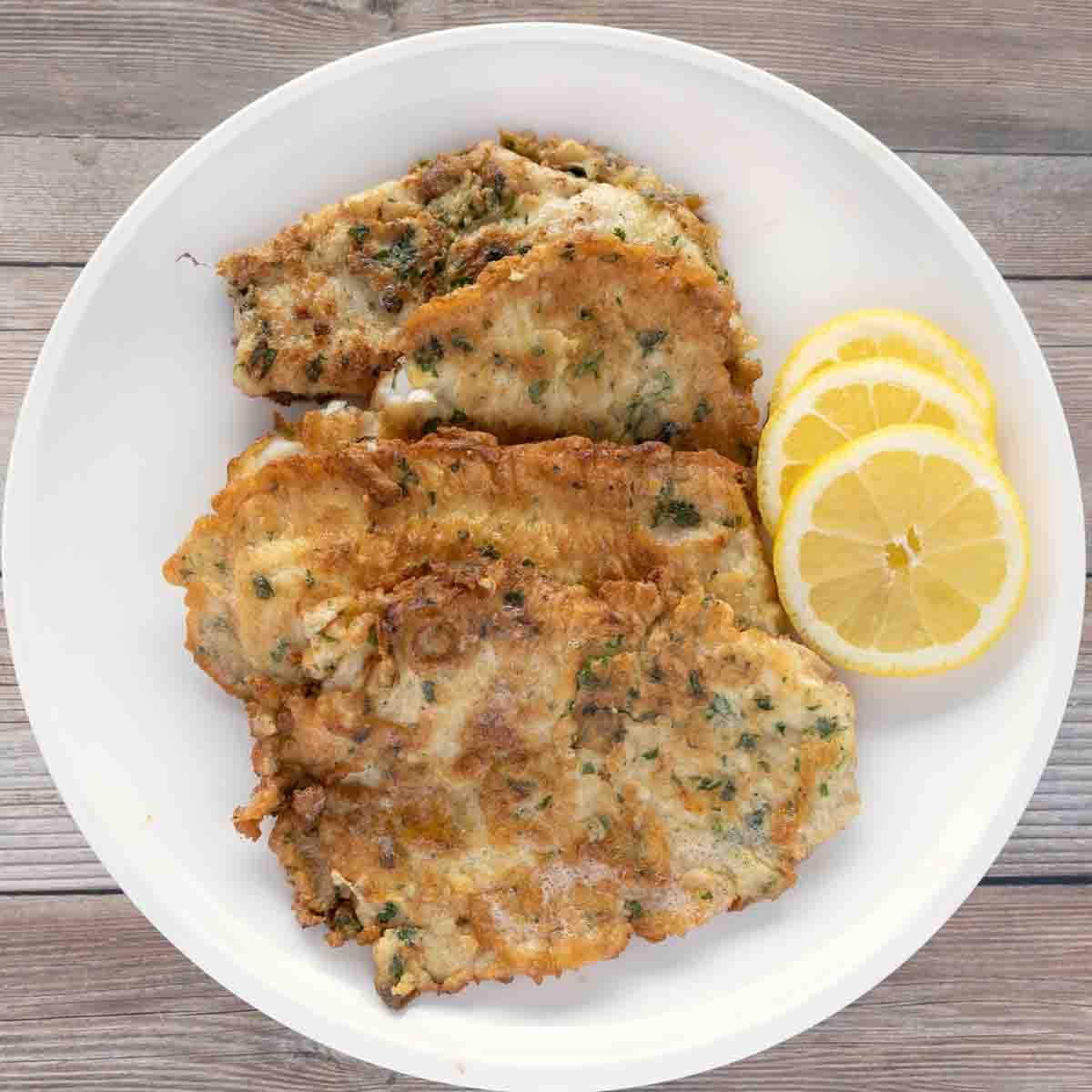 flounder francaise with lemon circles on a white plate