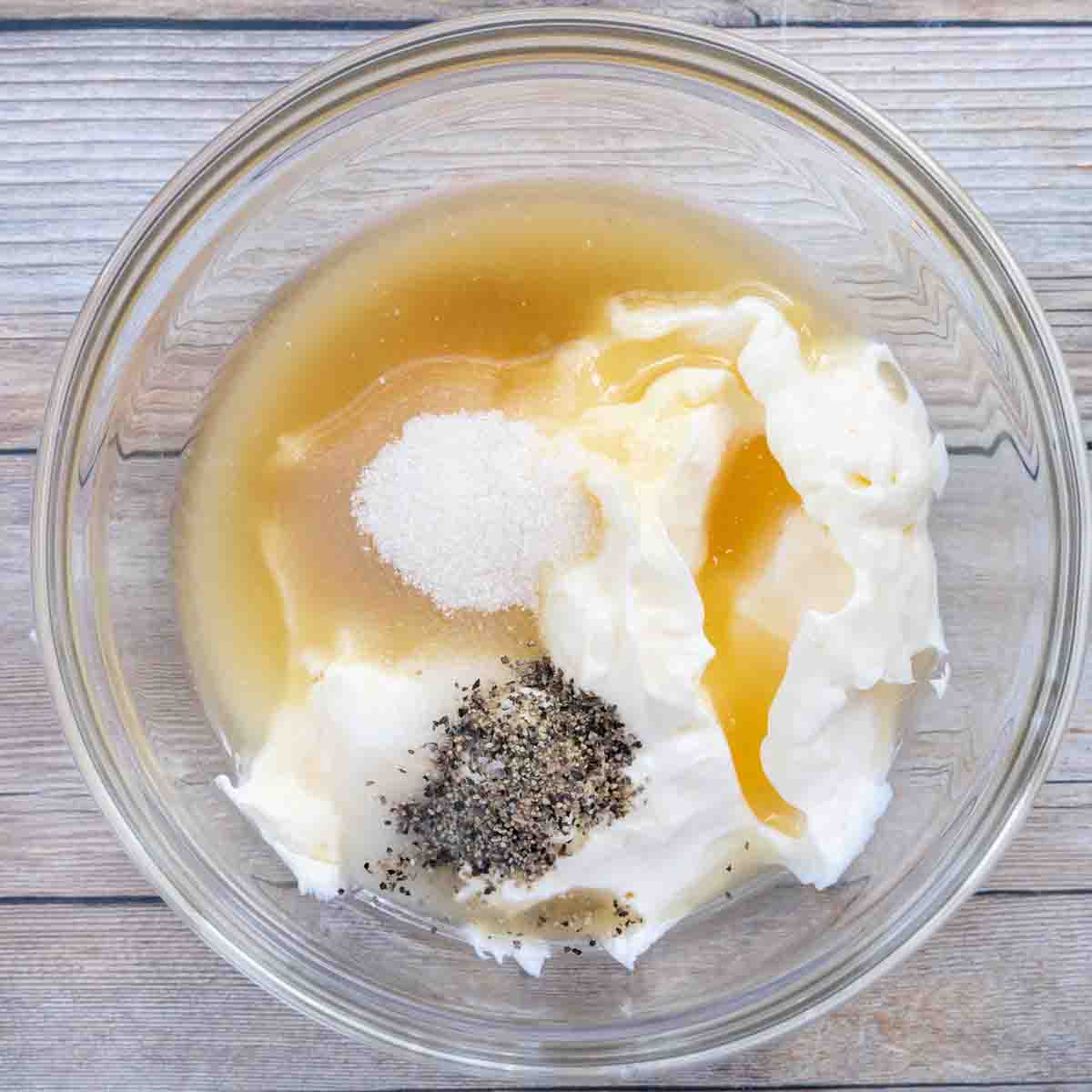 ingredients to make dressing in a glass bowl.