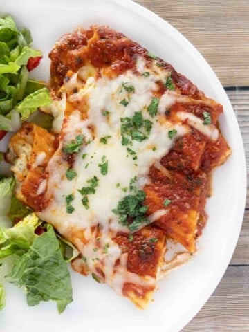 baked manicotti on a white plate.