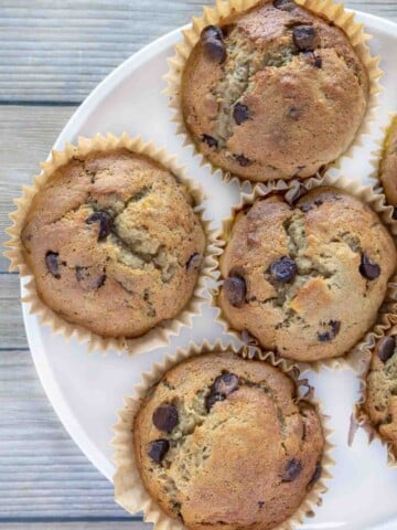 banana chocolate chip muffins on a white plate