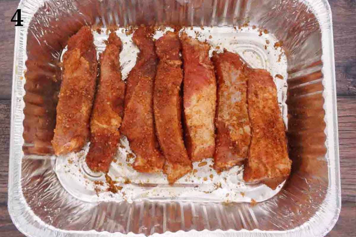 seasoned pork in foil pan.