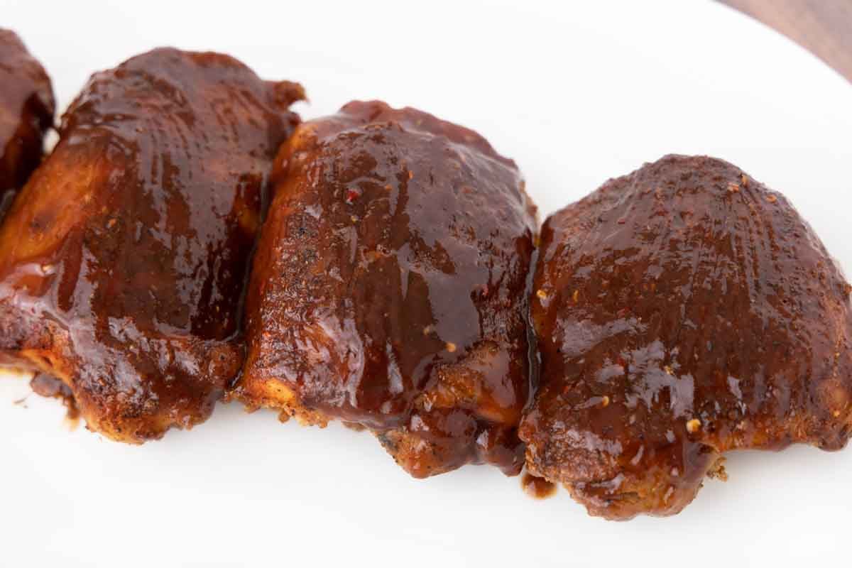 smoked chicken thighs coated in barbecue sauce.