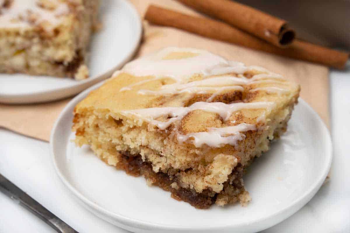 slice of cinnamon roll cake on a white plate.