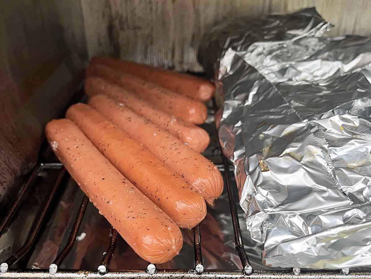 seasoned hot dogs in smoker.