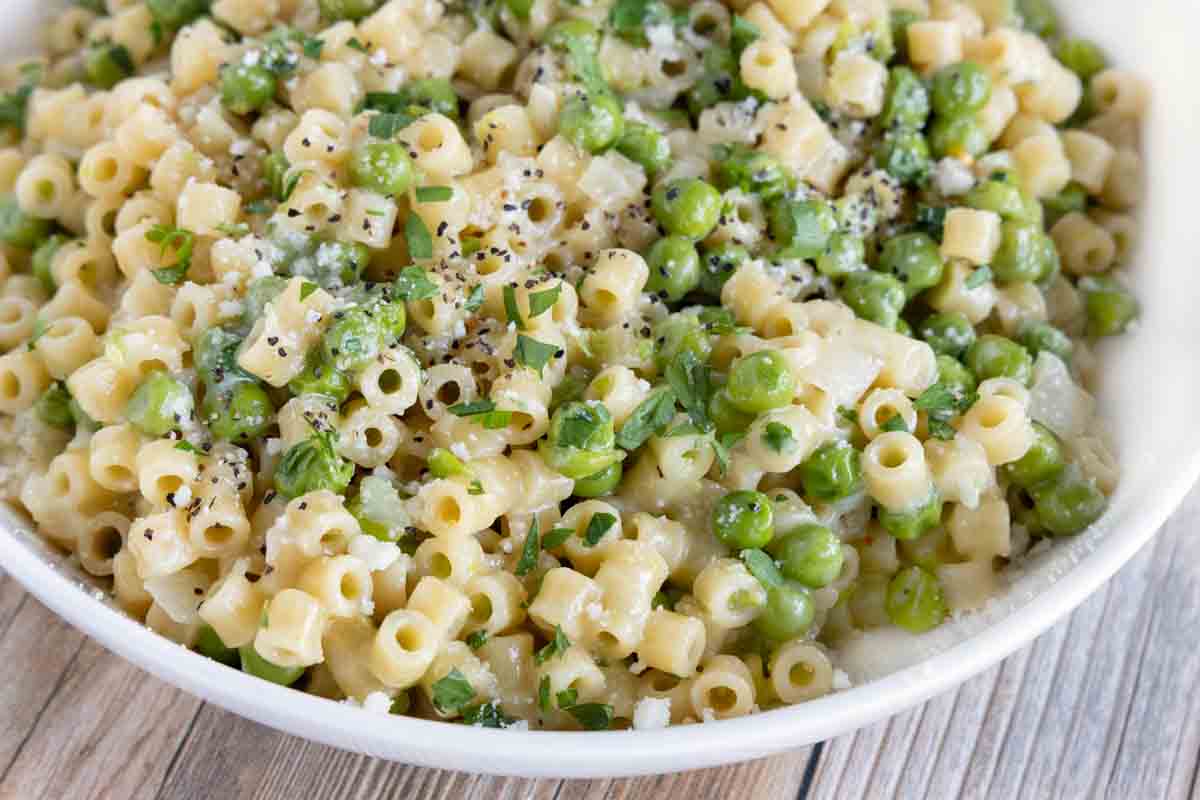 pasta e piselli (pasta with peas) in a white bowl.