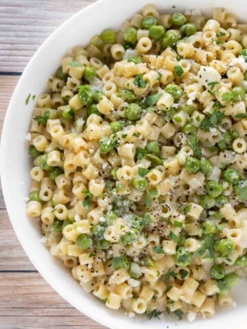 pasta e piselli (pasta with peas) in a white bowl.