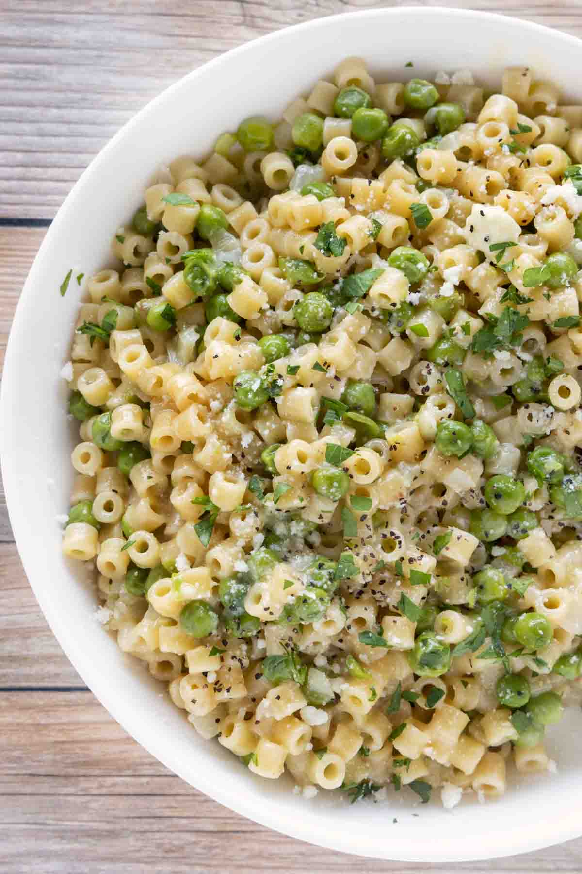 pasta e piselli (pasta with peas) in a white bowl.