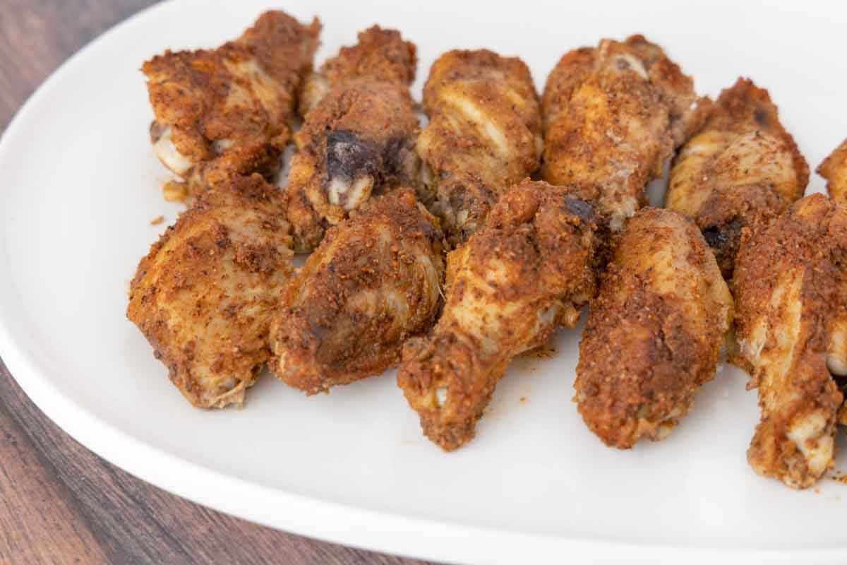 Finished wings on a white platter.