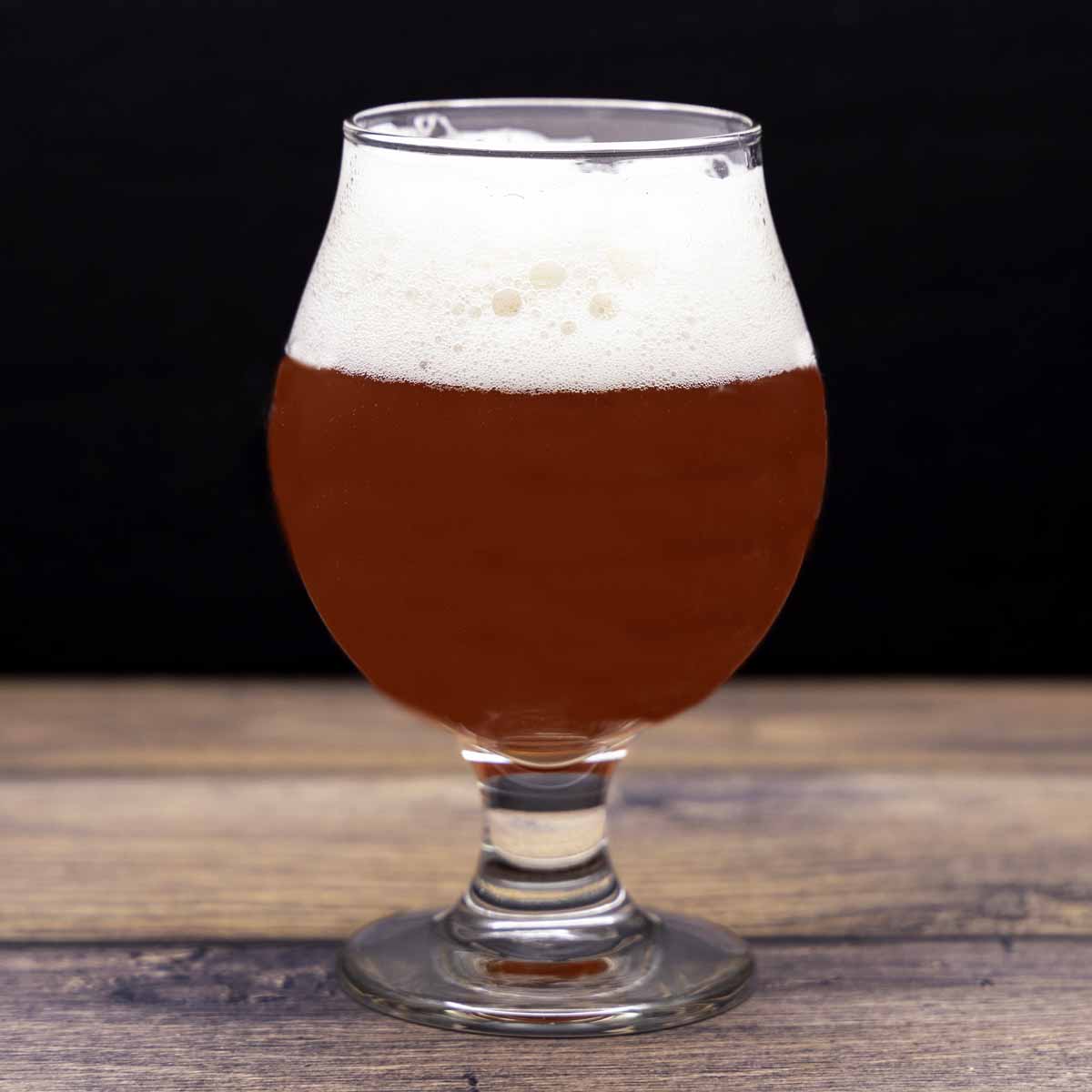 glass of sour beer shown with my beer and food pairing guide.