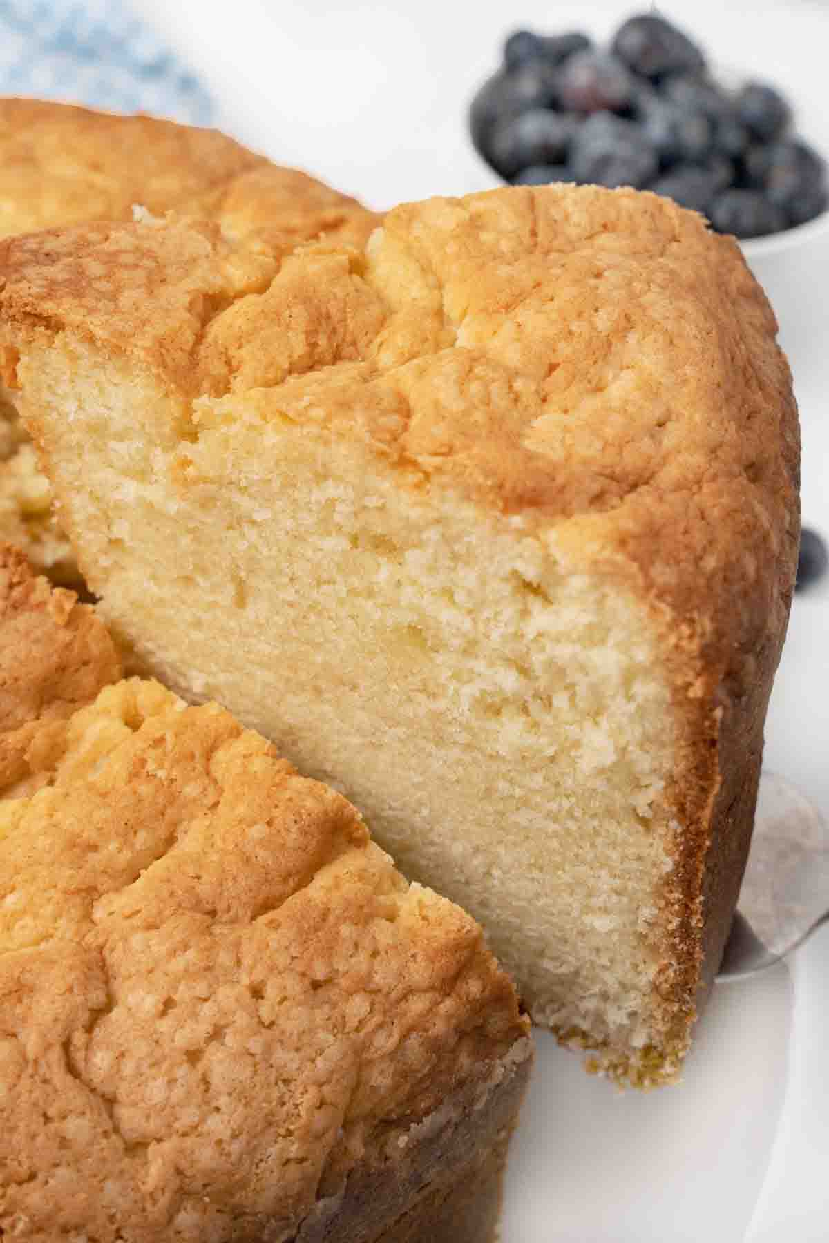 slice of sour cream pound cake taken out of whole cake.