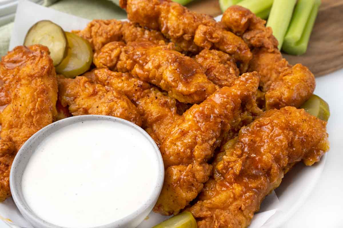 Nashville hot chicken tenders with pickles and bleu cheese dressing.