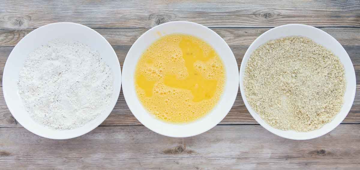 breading station set in white bowls.