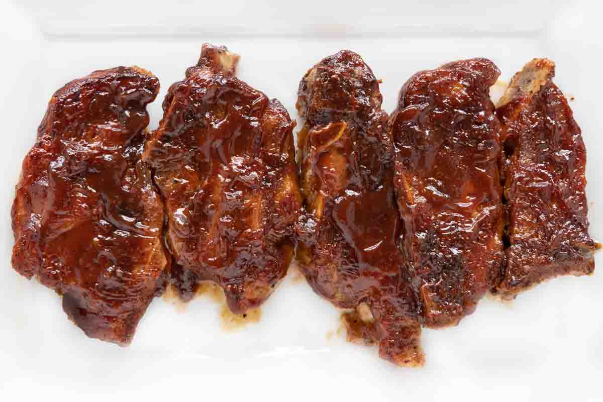 Barbecued country style pork ribs on a white platter