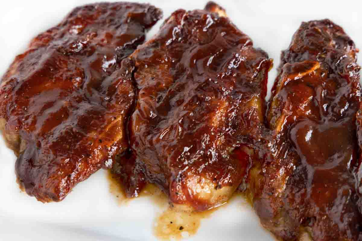 Barbecued country style pork ribs on a white platter