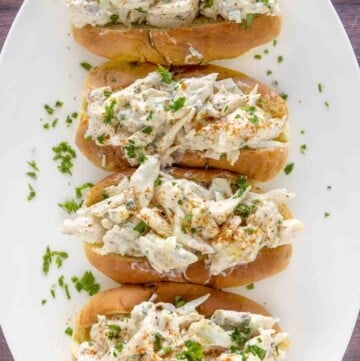 four Crab Rolls on a white plate.