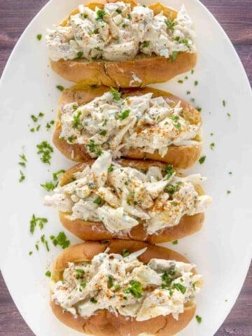 four Crab Rolls on a white plate.