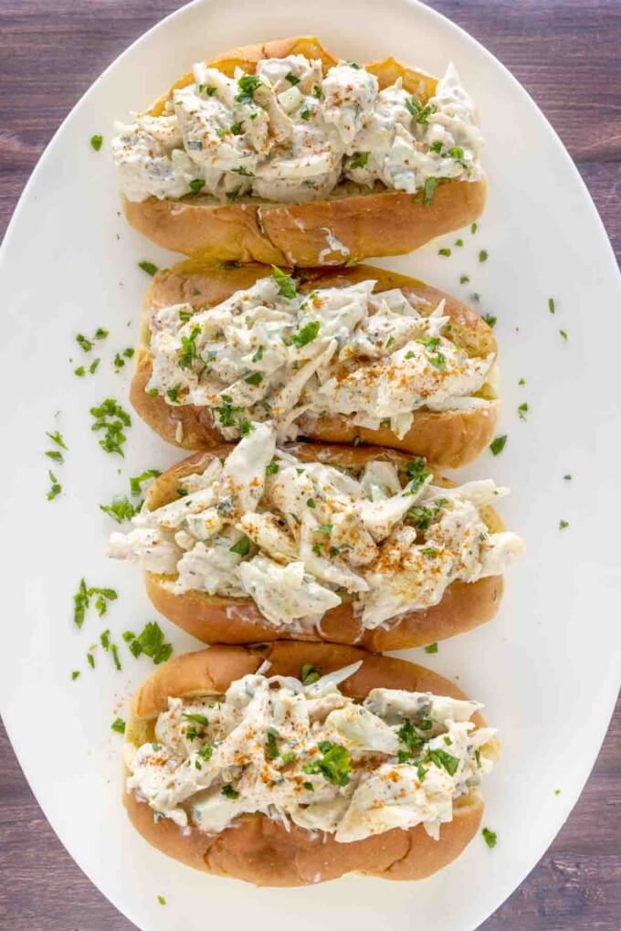 four Crab Rolls on a white plate.