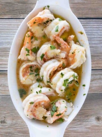 garlic butter shrimp in a white casserole dish.