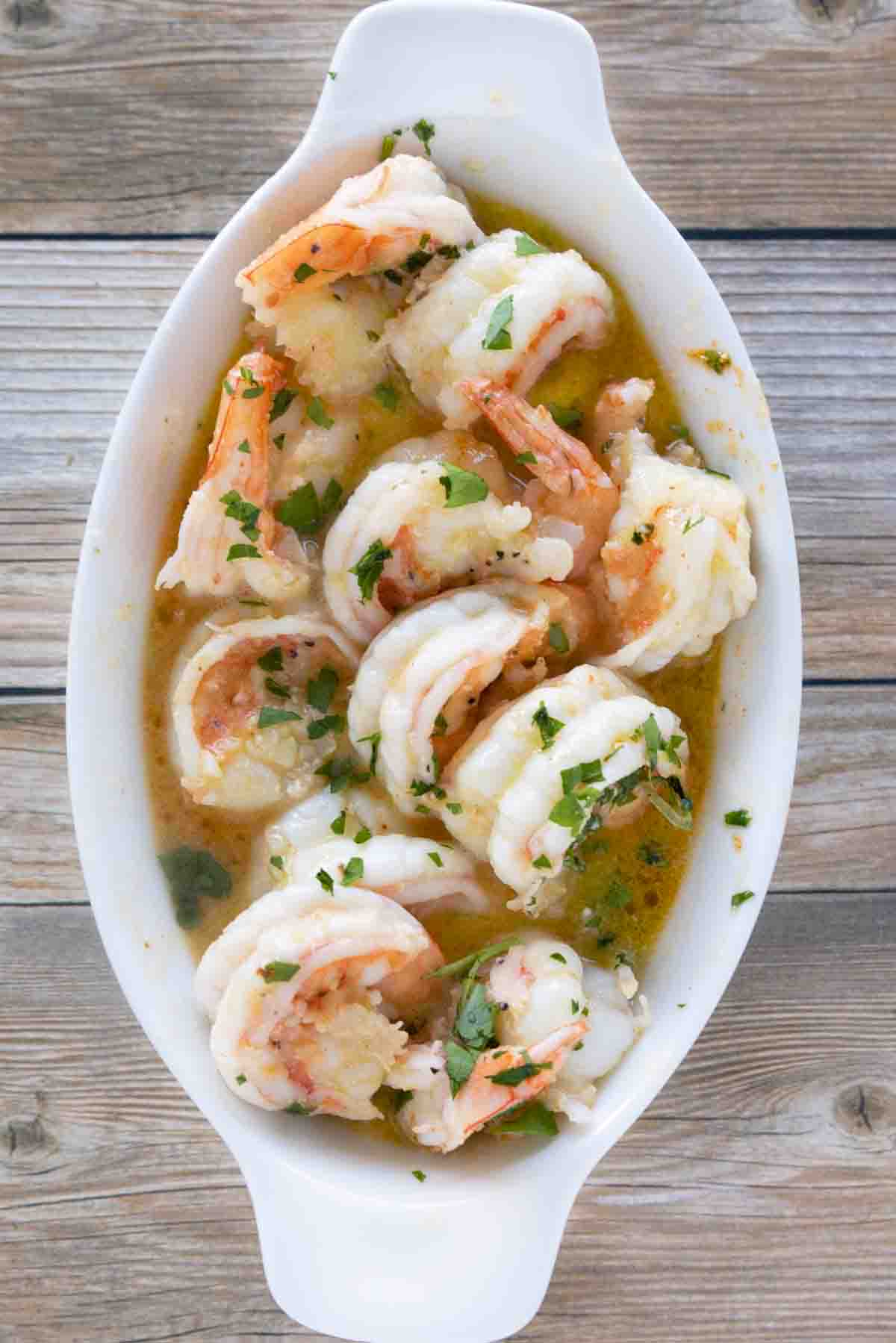 garlic butter shrimp in a white casserole dish.