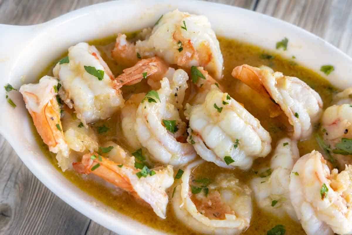 garlic butter shrimp in a white casserole dish.