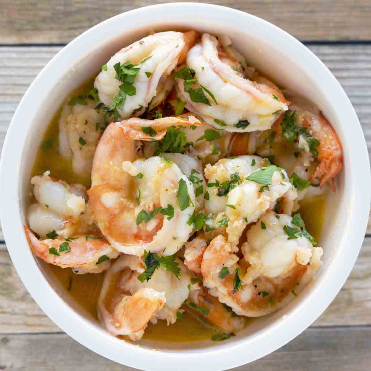 garlic butter shrimp in a white casserole dish.