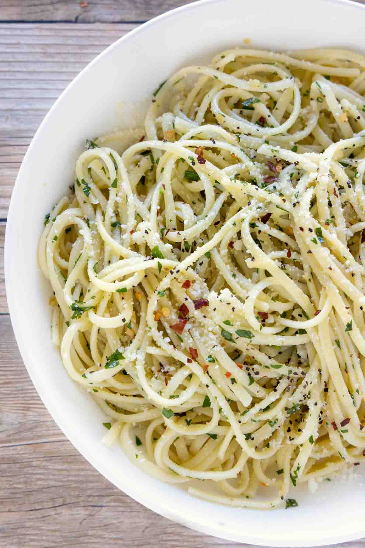 pasta with olive oil and garlic in a white bowl (pasta aglio e olio).