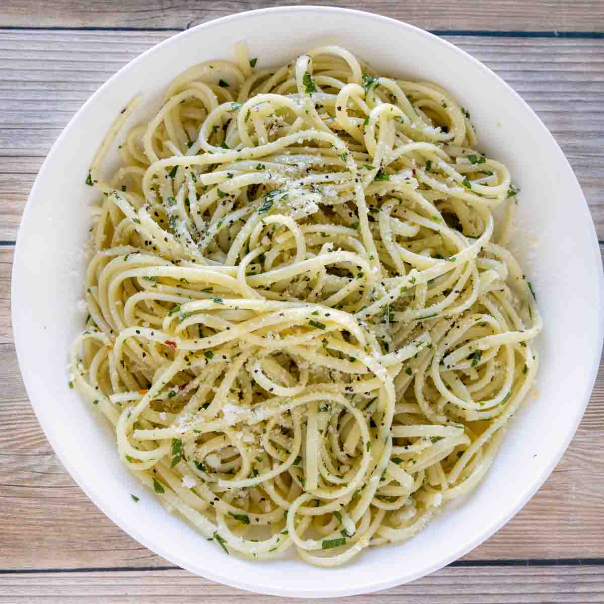 pasta with olive oil and garlic in a white bowl (pasta aglio e olio).