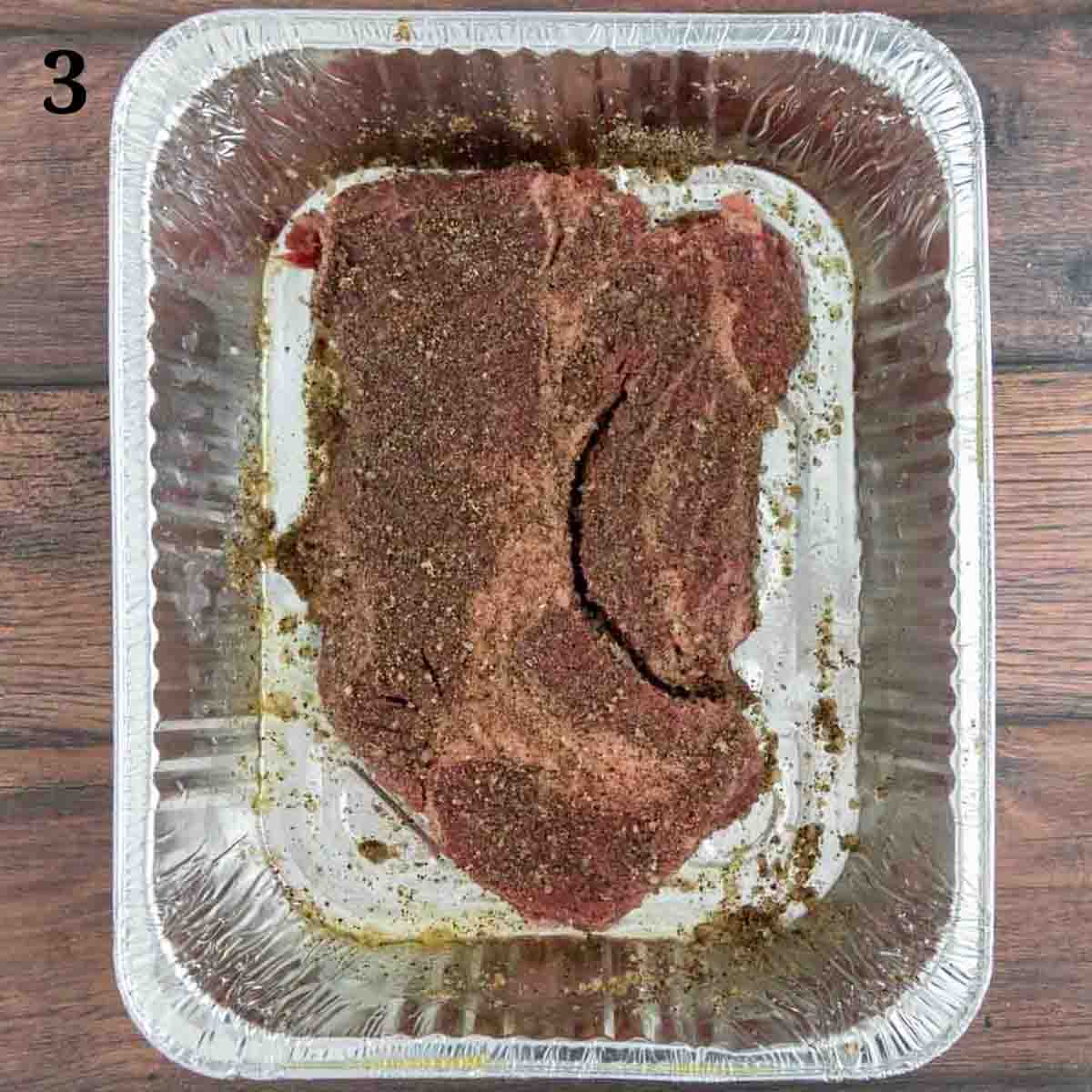 seasoned beef in a disposable foil pan.