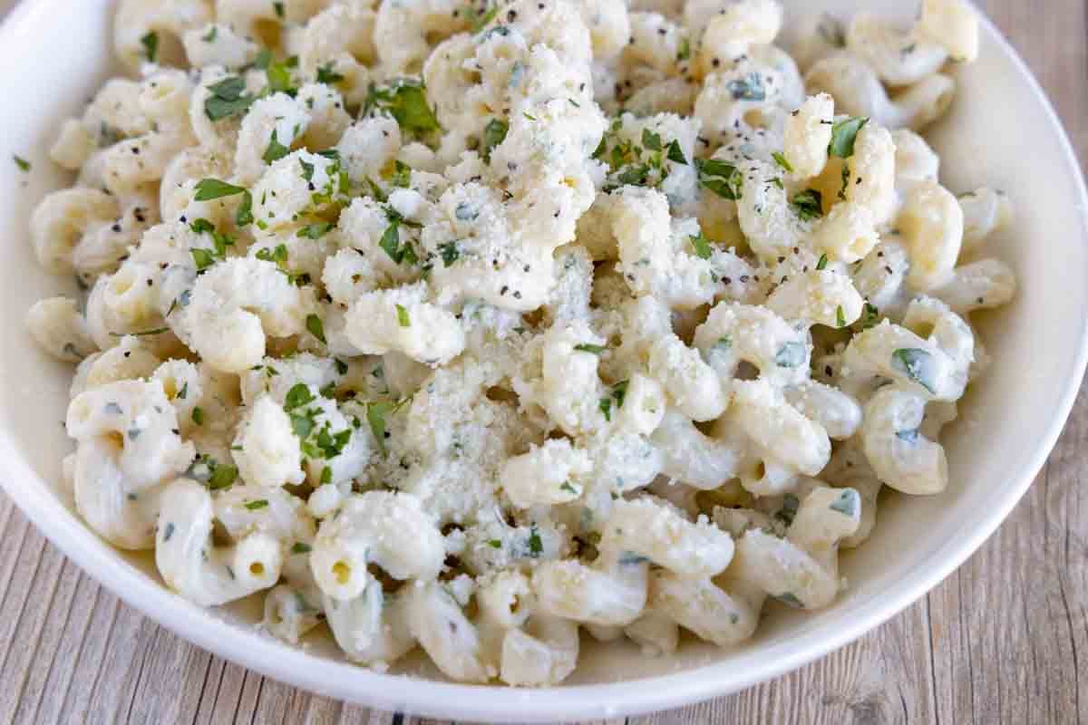 cream cheese pasta in a white bowl.