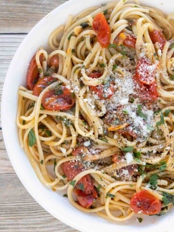 tomato basil pasta in a white bowl.