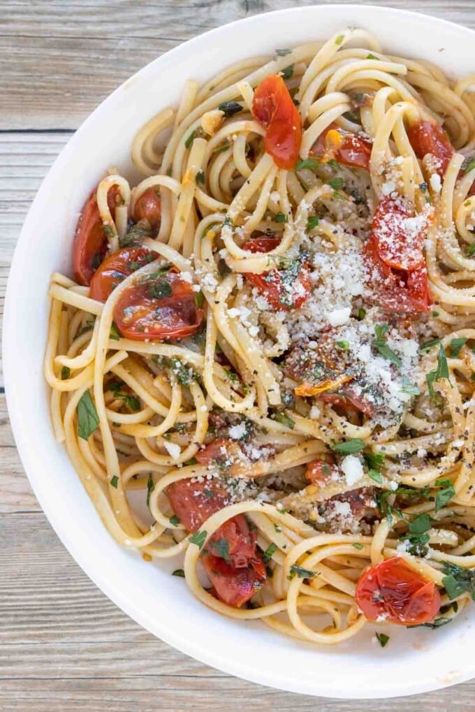 tomato basil pasta in a white bowl.