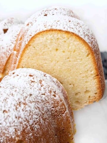 Slice being taken out of whole cream cheese pound cake.