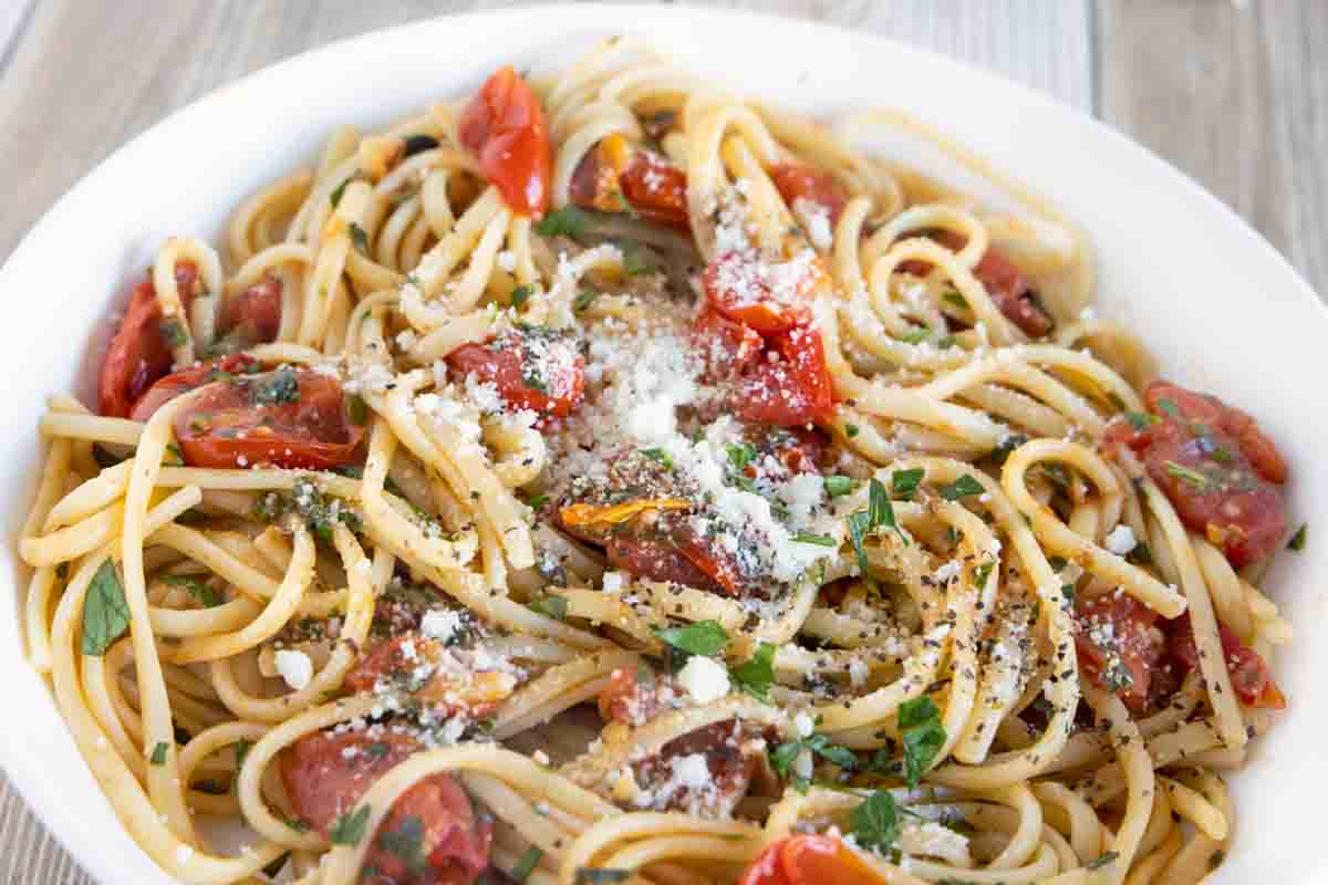 tomato basil pasta in a white bowl.